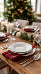 Festively arranged table with stacked plates, a decorative napkin, and a touch of greenery, all set against a blurred festive backdrop
