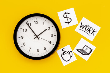 Wall clock and many paper cards with hand drawing of different life activities, top view. Time...
