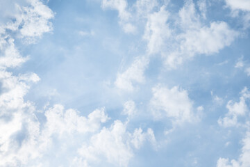 Bright blue sky with fluffy white clouds, peaceful and calm nature background. Sky clouds perfect for design, landscape concepts, travel themes, banners and digital projects.