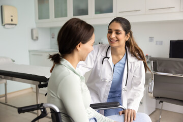 Obraz premium Positive caring young Indian doctor giving support