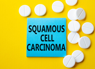 Squamous Cell Carcinoma symbol. Concept words Squamous Cell Carcinoma on blue note. Beautiful...