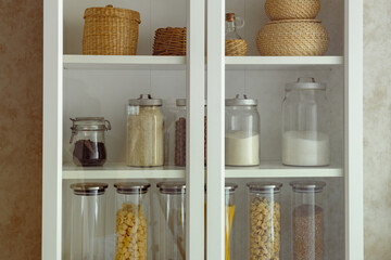 a cook's essential store cupboard ingredients, zero waste storage. Country kitchen setting. Dried food supplies.