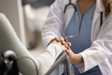 Fototapeta premium Sympathetic doctor giving comfort, psychological help to woman with disability