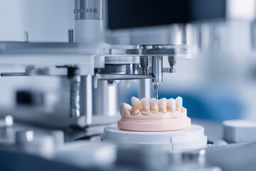 Modern dental lab machine mills ceramic tooth model