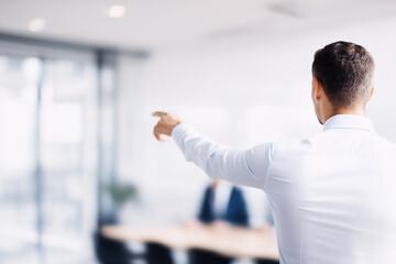 Man showing thumbs up gesture during team meeting. Symbolizing approval and agreement in teamwork