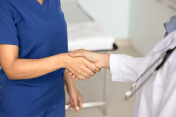 Two female doctors giving handshake close up