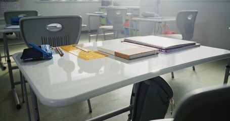 Close Up Shot of School Desk with Student School Supplies: Pencil Case, Pens and Pencils, Notebooks. Classroom of Modern Elementary School, Educational and Inspiring Learning Environment for Children.