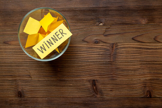 Winner on piece of paper in glass jar, top view. Luck and success concept.