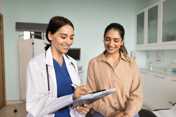 Happy general practitioner woman giving consultation to patient