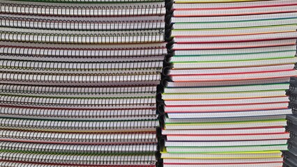Stack of colorful spiral and composition notebooks for school and office supplies. Horizontal...