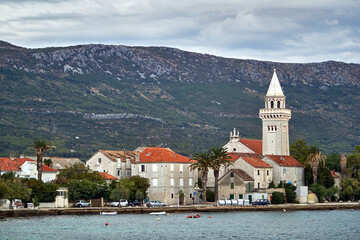 Stone houses and the bell tower of a historic church in the town of Kastel on the Adriatic coast