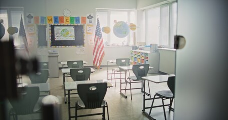 American Primary School: Interior of Modern Empty Classroom with Desks for Students, Chalkboard, Hanging Models of Solar System and Colorful Posters. Creative Space for Children Studying, Education.