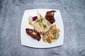 Sauce Fried Chicken, Fried Rice, and Vegetable Stir fry in plate top view of Delicious Asian Platter