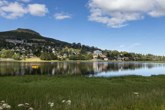Summer evening view with beautiful light, of Lac des Hermines (lake) at Super Besse ski resort, near Besse-et-Saint-Anastaise, in France. Copy space above and below.