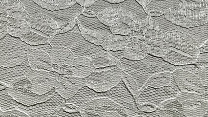 delicate white floral lace fabric closeup with mesh texture ideal for wedding background or vintage textile design