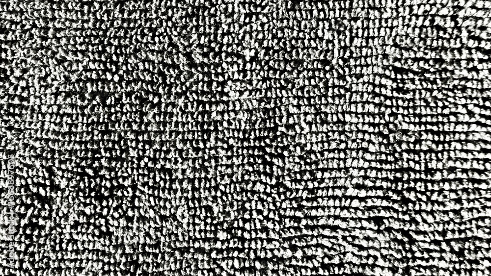 Poster closeup of black and white loop pile carpet surface creating dense textured pattern suitable for mod