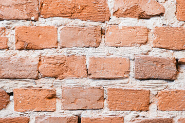 Old red brick wall texture. Rustic surface with rough cement joints. Vintage construction material background. Industrial masonry pattern. Architectural element for design and building inspiration.
