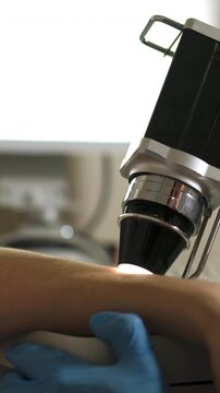 Vertical video. Trichologist conducts close-up examination in medical center. Concept of innovative technology for precise diagnostics of hair and skin health.