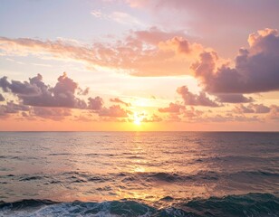 Fototapeta premium A vibrant pastel sunset over the ocean horizon with glowing skies and soft clouds. Perfect for digital wallpaper or calming backgrounds.