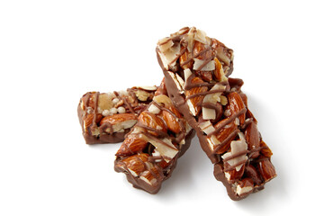 three sweet nut caramel bars stacked on top of each other isolated on white background