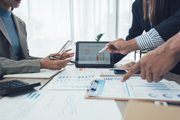 Business team meeting to analyze and discuss the situation in the financial report in the meeting room, investment consultant, financial consultant and accounting consultant.