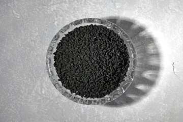 black cumin seeds nigella sativa in glass crystal bowl