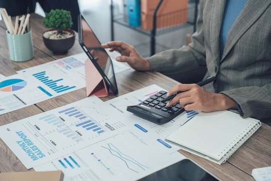 Auditor and accountant team working in office, analyze financial data and accounting record with calculator. Accounting company provide finance and taxation planning for profitable cash flow. Insight