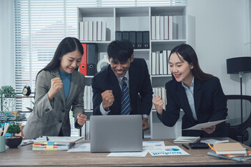 Two young Asian businesswoman discuss investment project working and planning strategy. Business people talking together with laptop computer at office.
