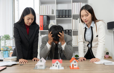 Real Estate Dilemma: A team contemplates over property models, each visibly stressed, their...