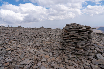 Rocky Mountain Summit with Distant Lake and Cloudy Sky