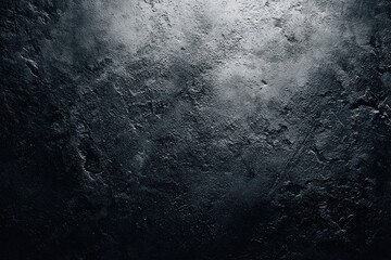Dark, textured wall with a central light source highlighting uneven, rough surface; shades of gray and black