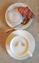 Breakfast - cappuccino, milk dessert and croissant