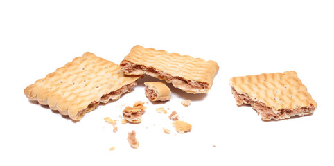 Broken rectangular double color biscuit and crumbs, pile cookies isolated on white, side view