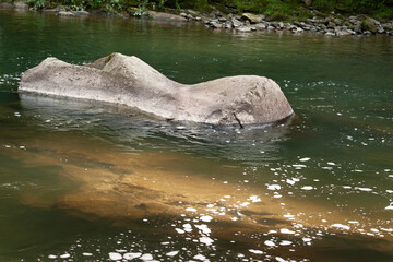Stone texture. Huge stone in mountain river. Large stones in the mountains