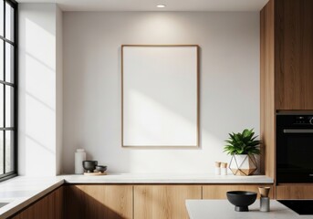 Modern minimalist kitchen interior with blank framed poster, wooden cabinets, white countertop, and natural light