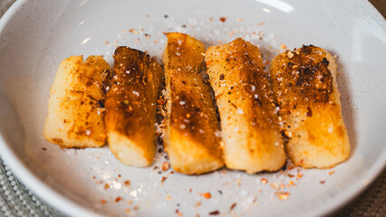 Crispy golden fried cassava sticks seasoned with aromatic spices and chili peppers. A perfect savory snack, ideal for Brazilian cuisine themes, street food, and appetizer menus.