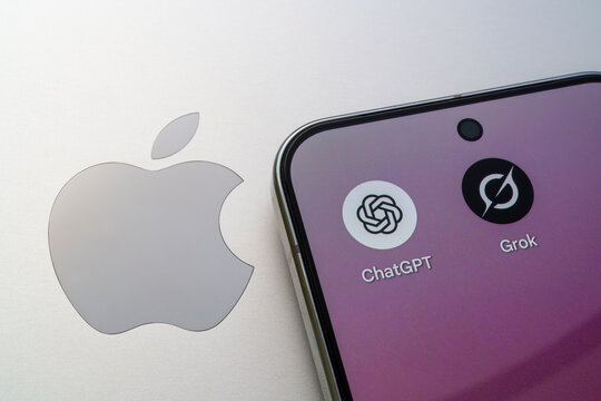 ChatGPT and Grok AI chatbot apps on smartphone screen next to Apple logo, showing tech rivalry and mobile AI. Stafford, United Kingdom, August 26, 2025