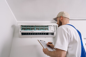 Expert technician performs air conditioning maintenance and repairs in an apartment