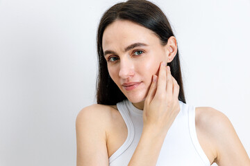 Young woman showcasing her skincare routine with a focus on natural beauty