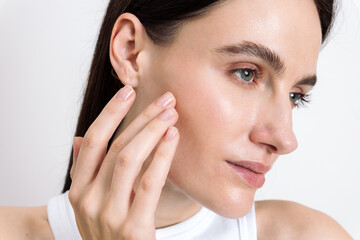 Young woman showcasing her skincare routine for healthy, glowing skin