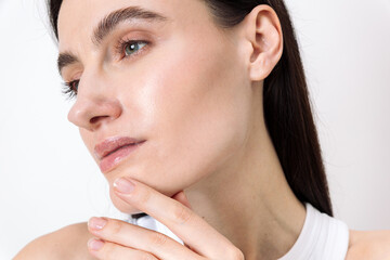 Skincare routine of a young woman with clear skin on a white background