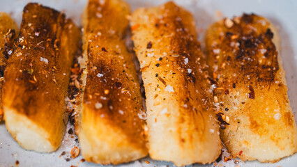 Crispy golden fried cassava sticks seasoned with aromatic spices and chili peppers. A perfect savory snack, ideal for Brazilian cuisine themes, street food, and appetizer menus.