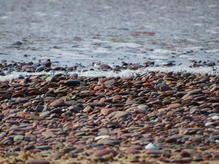 wallpaper of different colored stones on the beach in summer and sea