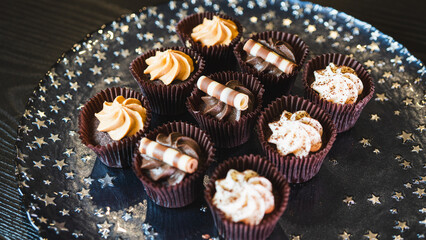 Beautiful assorted chocolate cupcakes with creamy frosting and colorful toppings, styled on a chic plate. Ideal for dessert content, baking inspiration, and joyful food storytelling.