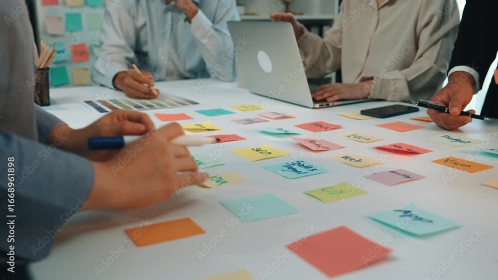 Poster a cohesive team collaborates in a modern office, using colorful sticky notes to convey ideas, while 