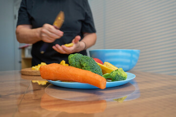 Chopping fresh vegetables in a cozy kitchen with vibrant ingredients on a blue plate