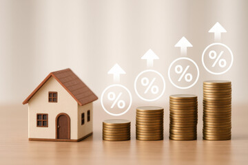 Small house model with increasing stacks of coins and percentage symbols showing financial growth