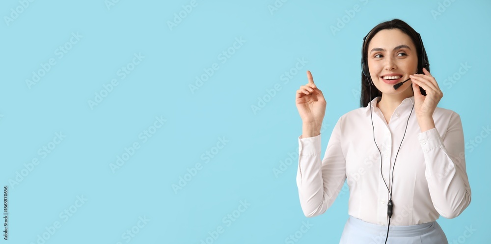 Poster female technical support agent in headset pointing at something on blue background with space for te