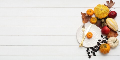 Beautiful autumn table setting with pumpkins and apples on white wooden background with space for text