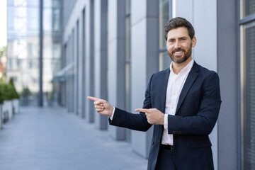 Fototapeta premium Confident businessman pointing with a smile in modern urban office setting